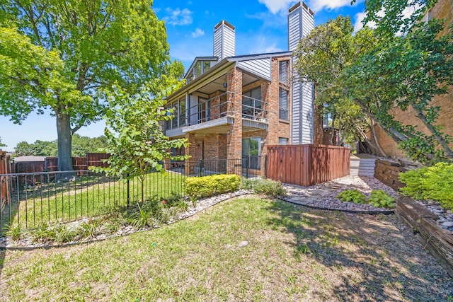 510 Columbia Dr, Rockwall, TX 75032 - back of property featuring a chimney, a balcony, and brick siding