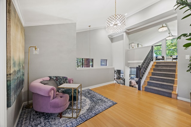 510 Columbia Dr, Rockwall, TX 75032 - sitting room featuring crown molding, wood finished floors, baseboards, a chandelier, and stairs