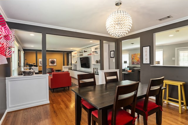 9914 Woodgrove Dr, Dallas, TX 75218 - dining area featuring ornamental molding, wood finished floors, a chandelier, and recessed lighting