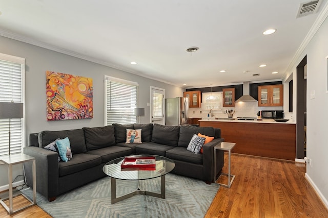 9914 Woodgrove Dr, Dallas, TX 75218 - living room featuring recessed lighting, ornamental molding, light wood-style floors, and baseboards