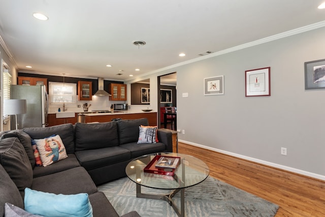 9914 Woodgrove Dr, Dallas, TX 75218 - living area featuring ornamental molding, recessed lighting, wood finished floors, and baseboards