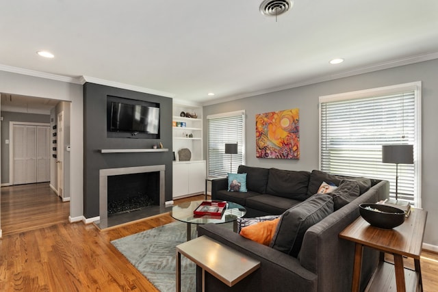 9914 Woodgrove Dr, Dallas, TX 75218 - living area with a fireplace, crown molding, light wood-type flooring, recessed lighting, and baseboards