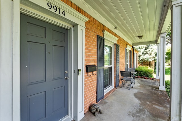 9914 Woodgrove Dr, Dallas, TX 75218 - view of exterior entry with covered porch and brick siding