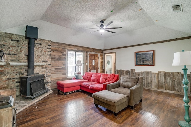 1312 Robyn Rd, Azle, TX 76020 - living area with vaulted ceiling, ceiling fan, a textured ceiling, hardwood / wood-style floors, and a wood stove