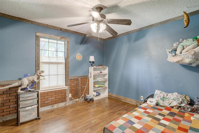 1312 Robyn Rd, Azle, TX 76020 - bedroom featuring a textured ceiling, wood finished floors, a textured wall, ceiling fan, and baseboards
