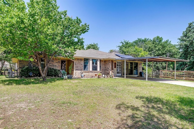 1312 Robyn Rd, Azle, TX 76020 - view of front of home featuring brick siding, roof mounted solar panels, and a carport