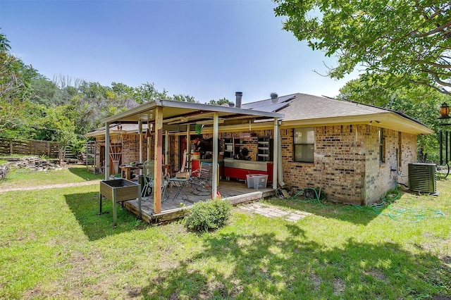 1312 Robyn Rd, Azle, TX 76020 - rear view of house with central AC, brick siding, solar panels, and a shingled roof