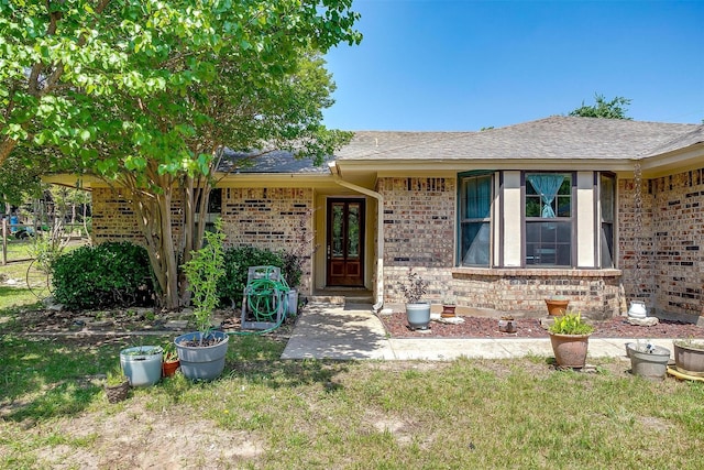 1312 Robyn Rd, Azle, TX 76020 - property entrance featuring brick siding, a shingled roof, and a lawn