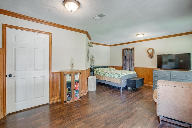 1312 Robyn Rd, Azle, TX 76020 - bedroom featuring a wainscoted wall, wood finished floors, a textured ceiling, crown molding, and wooden walls