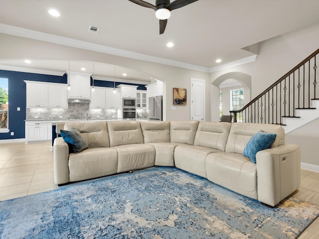 318 Arcadia Way, Rockwall, TX 75087 - living area with ceiling fan, arched walkways, ornamental molding, healthy amount of natural light, and recessed lighting