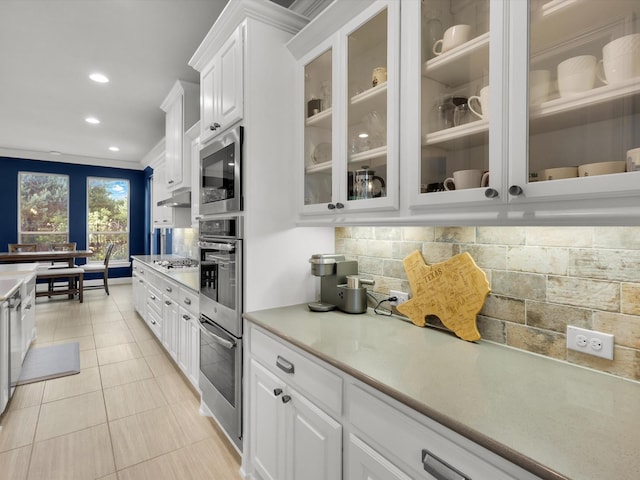 318 Arcadia Way, Rockwall, TX 75087 - kitchen featuring appliances with stainless steel finishes, white cabinetry, decorative backsplash, glass insert cabinets, and recessed lighting