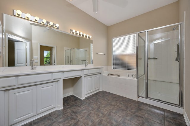 8256 Bridge St, North Richland Hills, TX 76180 - bathroom with double vanity, a bath, a shower stall, a ceiling fan, and tile patterned flooring