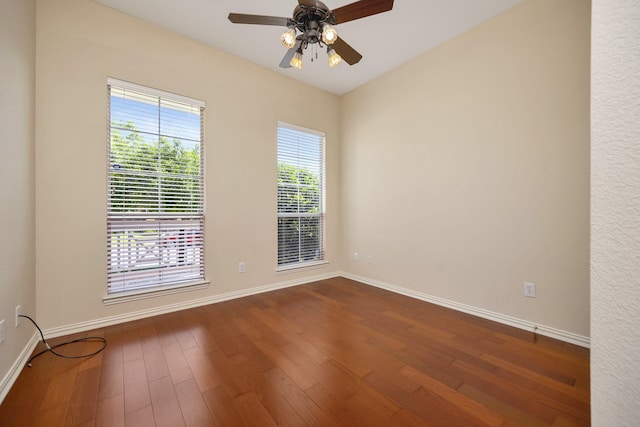 8256 Bridge St, North Richland Hills, TX 76180 - spare room featuring baseboards, dark wood-style flooring, and a ceiling fan