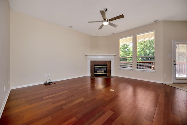 8256 Bridge St, North Richland Hills, TX 76180 - unfurnished living room featuring wood finished floors, a ceiling fan, a fireplace, and baseboards