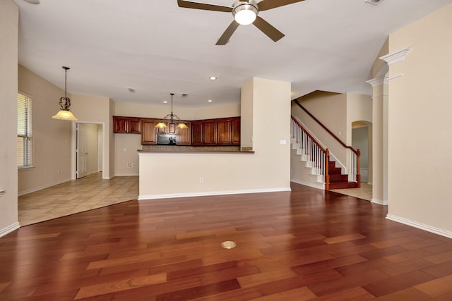 8256 Bridge St, North Richland Hills, TX 76180 - unfurnished living room featuring a ceiling fan, stairway, arched walkways, dark wood finished floors, and recessed lighting