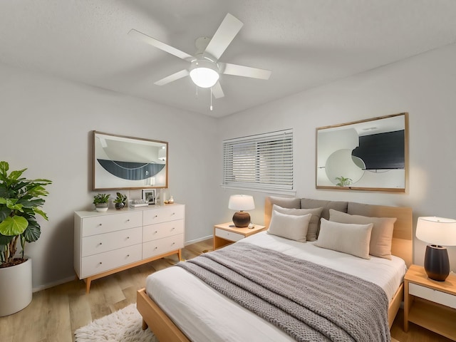 300 Lark Ln, Euless, TX 76039 - bedroom with light wood finished floors, baseboards, and a ceiling fan