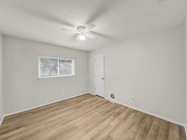 300 Lark Ln, Euless, TX 76039 - unfurnished room featuring a ceiling fan, light wood-style floors, baseboards, and a textured ceiling