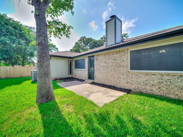 300 Lark Ln, Euless, TX 76039 - back of house with a patio area, brick siding, a chimney, and central AC unit