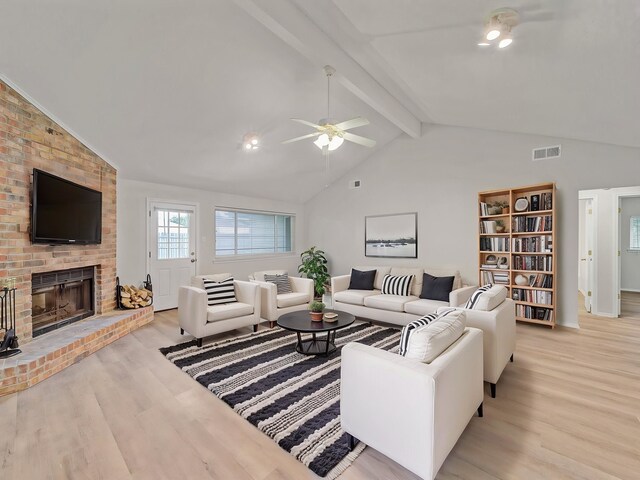 300 Lark Ln, Euless, TX 76039 - living room with light wood finished floors, a ceiling fan, a brick fireplace, and baseboards