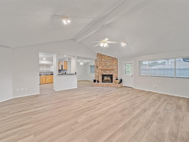 300 Lark Ln, Euless, TX 76039 - unfurnished living room with a ceiling fan, a brick fireplace, light wood finished floors, baseboards, and a textured ceiling