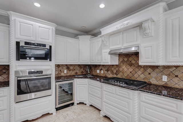 3005 S Jennings Ave, Fort Worth, TX 76110 - kitchen with wine cooler, stainless steel appliances, under cabinet range hood, a sink, and white cabinets