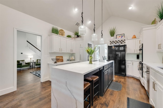 7709 Westwind Dr, Fort Worth, TX 76179 - kitchen featuring black appliances, white cabinets, a kitchen island, and high vaulted ceiling