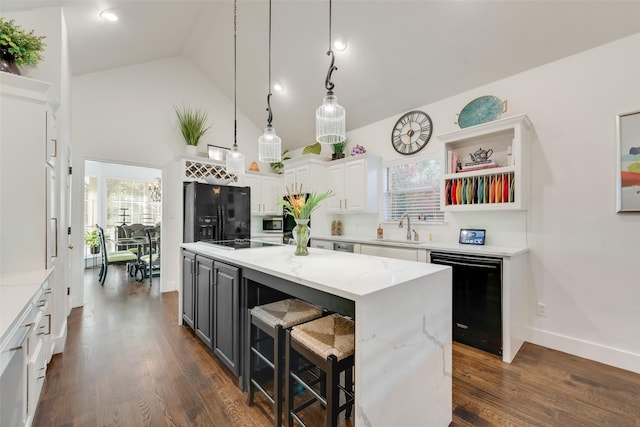 7709 Westwind Dr, Fort Worth, TX 76179 - kitchen featuring black appliances, a sink, white cabinets, a center island, and high vaulted ceiling