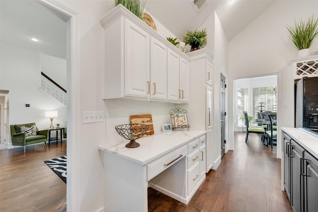 7709 Westwind Dr, Fort Worth, TX 76179 - hallway featuring dark wood-type flooring, stairway, and high vaulted ceiling