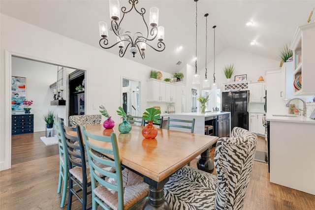7709 Westwind Dr, Fort Worth, TX 76179 - dining space with a chandelier, light wood-style floors, and high vaulted ceiling