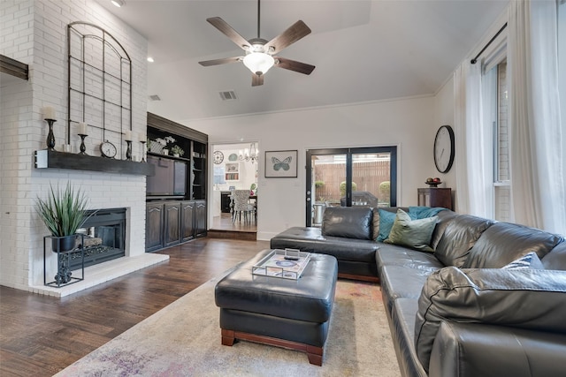 7709 Westwind Dr, Fort Worth, TX 76179 - living room with dark wood-style floors, ceiling fan, a fireplace, a chandelier, and high vaulted ceiling