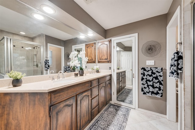 7709 Westwind Dr, Fort Worth, TX 76179 - full bathroom featuring double vanity, a stall shower, tile patterned flooring, and baseboards