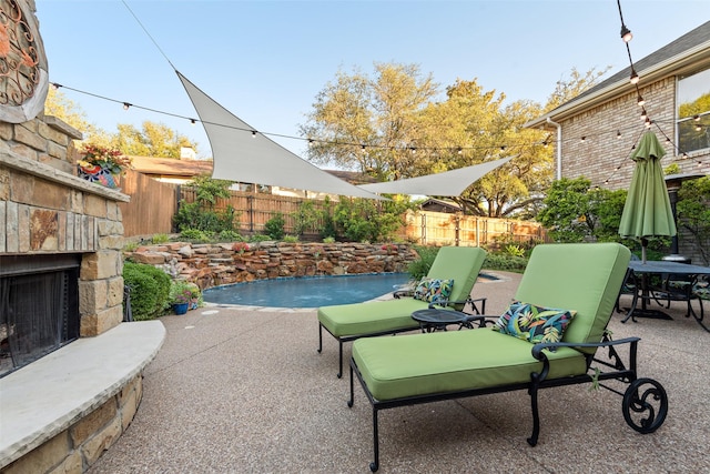 7709 Westwind Dr, Fort Worth, TX 76179 - fenced backyard with an outdoor stone fireplace and a patio
