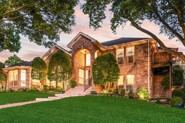 7709 Westwind Dr, Fort Worth, TX 76179 - view of front of house with brick siding, a lawn, and a balcony