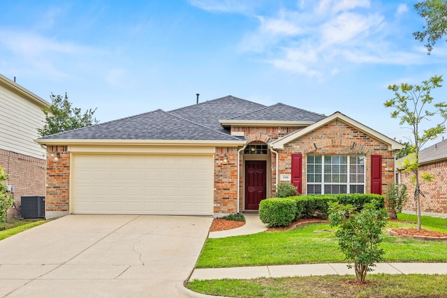 332 Butternut Dr, Fate, TX 75087 - view of front of house with an attached garage, driveway, central AC unit, roof with shingles, and brick siding