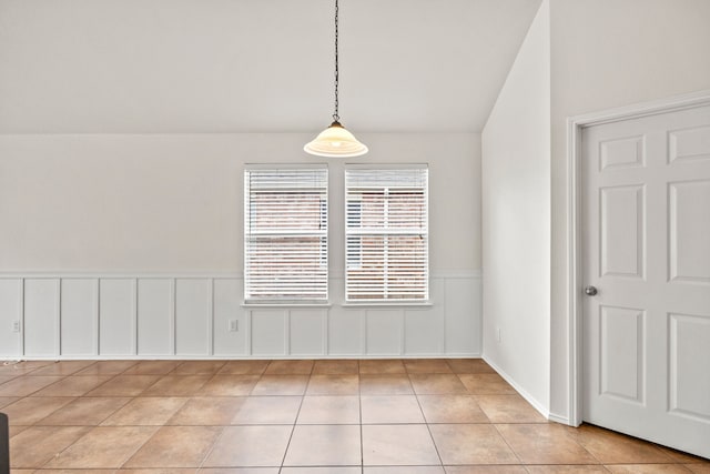 332 Butternut Dr, Fate, TX 75087 - unfurnished dining area with light tile patterned flooring, vaulted ceiling, and a wainscoted wall