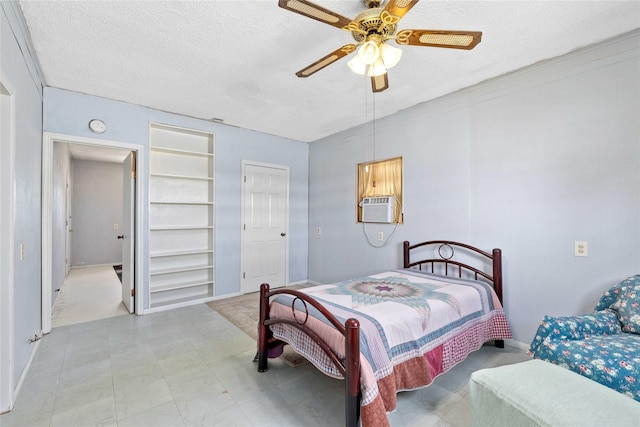 201 S 1st St, Bangs, TX 76823 - bedroom featuring a textured ceiling, cooling unit, a ceiling fan, and baseboards