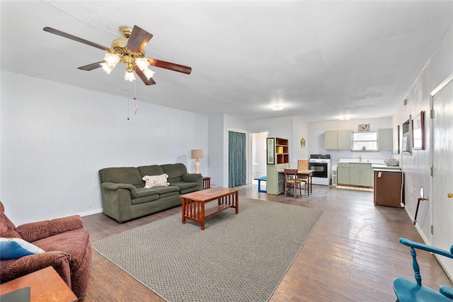 201 S 1st St, Bangs, TX 76823 - living area featuring dark wood-style floors, ceiling fan, and baseboards