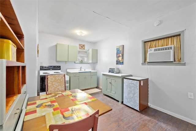 201 S 1st St, Bangs, TX 76823 - kitchen with green cabinets, white range with electric stovetop, wood finished floors, baseboards, and an AC wall unit