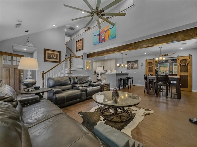 7409 Harbor Dr, Rowlett, TX 75088 - living area with ceiling fan, wood finished floors, high vaulted ceiling, a chandelier, and stairway