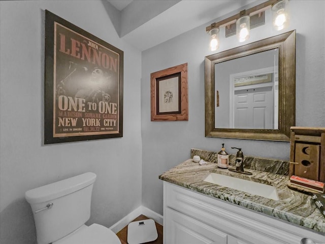 7409 Harbor Dr, Rowlett, TX 75088 - half bathroom featuring vanity, toilet, and baseboards