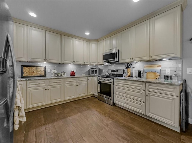 7409 Harbor Dr, Rowlett, TX 75088 - kitchen featuring appliances with stainless steel finishes, dark wood-style floors, backsplash, light stone countertops, and recessed lighting