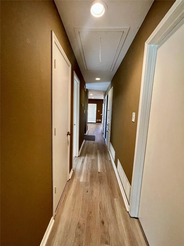 2955 Allister St, Dallas, TX 75229 - hallway with attic access, light wood-style flooring, and baseboards