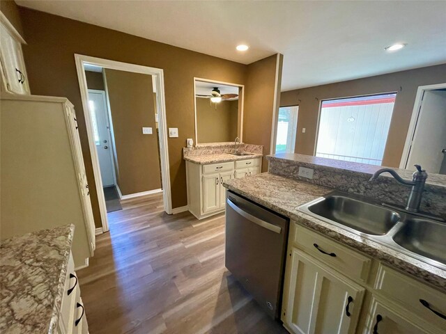 2955 Allister St, Dallas, TX 75229 - kitchen featuring stainless steel dishwasher, a sink, wood finished floors, white cabinetry, and recessed lighting