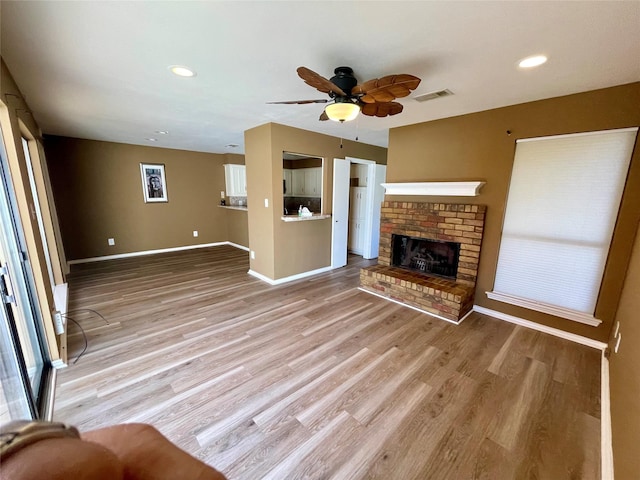 2955 Allister St, Dallas, TX 75229 - unfurnished living room featuring baseboards, light wood-style flooring, a ceiling fan, a fireplace, and recessed lighting