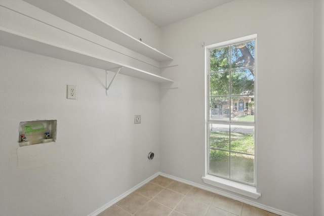 7100 Fox Dr, The Colony, TX 75056 - washroom with hookup for a washing machine, baseboards, and light tile patterned floors