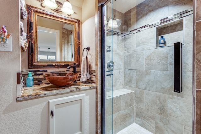 2801 Adams Dr, Melissa, TX 75454 - full bath featuring a shower stall, vanity, a textured wall, and tasteful backsplash