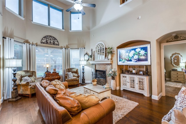 2801 Adams Dr, Melissa, TX 75454 - living area featuring a ceiling fan, hardwood / wood-style flooring, a fireplace, a high ceiling, and baseboards