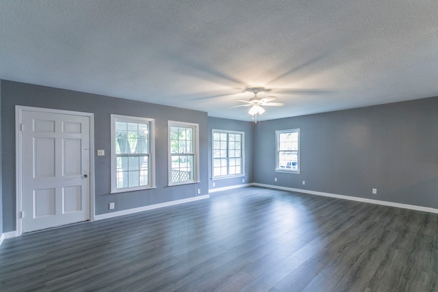 901 E Walnut St, Hillsboro, TX 76645 - unfurnished room featuring a textured ceiling, a ceiling fan, baseboards, and dark wood-type flooring