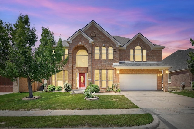 9829 Crawford Farms Dr, Fort Worth, TX 76244 - view of front of home with driveway, brick siding, a front lawn, and an attached garage