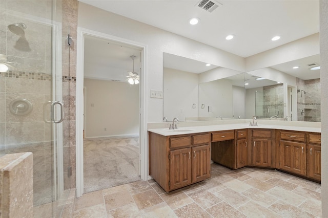 5518 Oak Branch Dr, Arlington, TX 76016 - bathroom featuring double vanity, a shower stall, stone tile floors, a ceiling fan, and recessed lighting